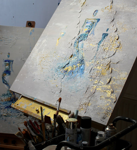 “SOUL III” by Atelier Marx in-progress on an easel, with textured brushstrokes, gold leaf details, and studio tools in view — capturing the tactile energy of creation.
